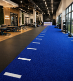 Modern indoor facility with a blue running track and various equipment.
